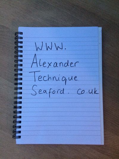 Photo of notebook with 'www.alexandertechniqueseaford.co.uk' hand written on page
