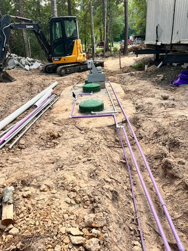 Concrete septic tank installation in Cleveland TX with new access lids installed by licensed SMP
