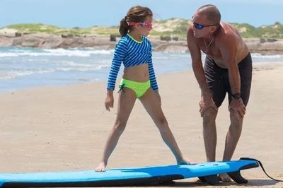 Gene Gore teaching surfing lesson to children at South Padre Island Texas