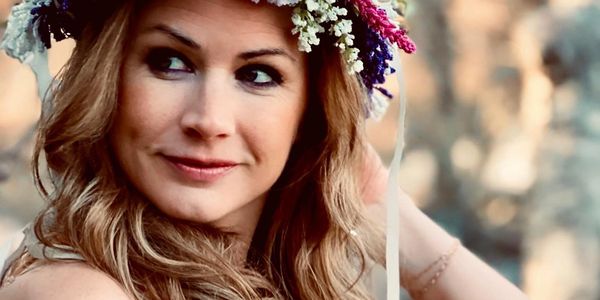 Woman smiling with flower crown in her hair
