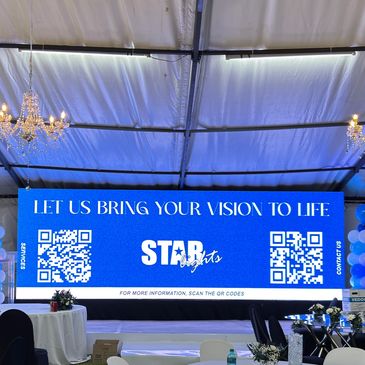 Large blue event screen with company logo and QR codes.
