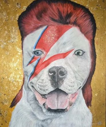 A dog painted with David Bowie's iconic lightning bolt and hairstyle.