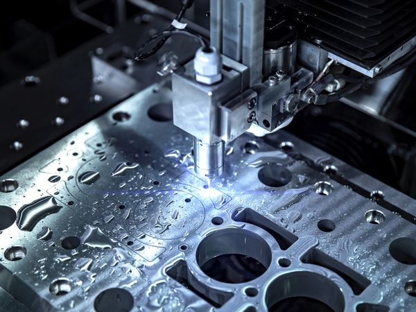Close-up of a CNC machine working on a metal part.