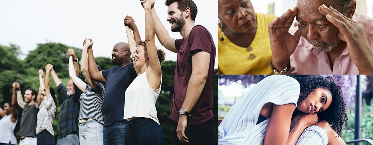 A diverse group of people holding hands in unity outdoors.