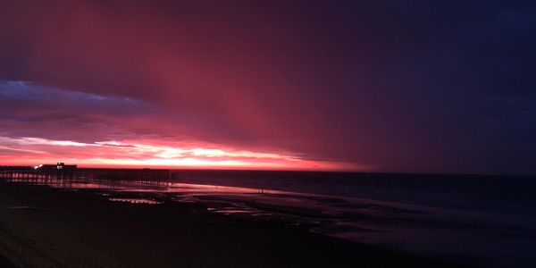 Pink and purple sunrise over a beach in Hastings East Sussex