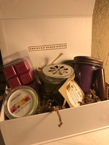 A gift box with candles and wax melts.