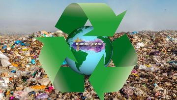 Green recycling symbol around Earth over a landfill background.