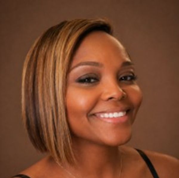 Smiling woman with side-parted hair.