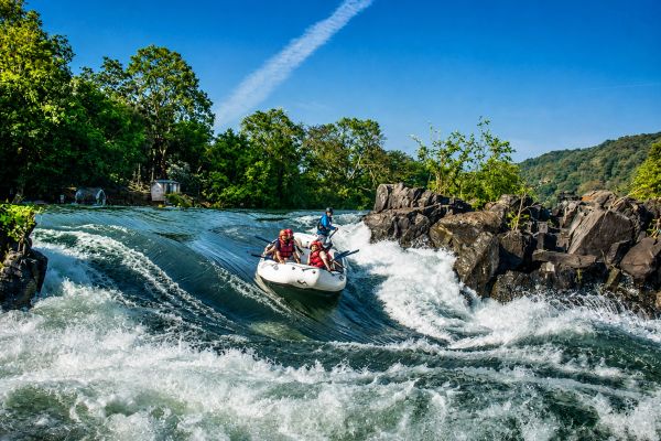 River Rafting at Dandeli River Resorts on the Kali River, navigating thrilling rapids surrounded by