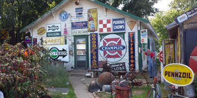Old house in Erik, Oklahoma displaying antique signs fro Route 66.
