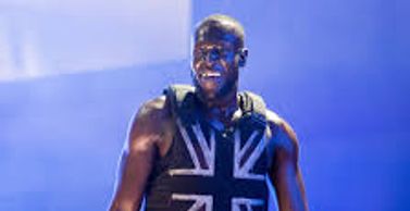 Performer in a sleeveless Union Jack top on stage.