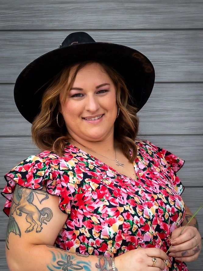 Pretty stylist  in hat with flower dress
