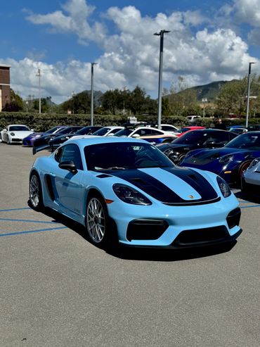 Light blue sports car with black stripes, available on request