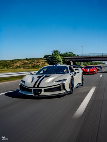 Gray exotic sports car with black racing stripes, available on request