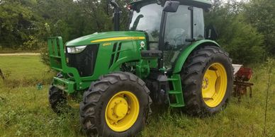 A big 6120 4 wheel drive John Deere tractor makes planting, bushhogging, and work child's play