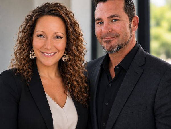 Smiling professional man and woman posing together.