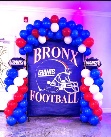 Red, white, and blue balloon arch with Bronx Giants football backdrop.