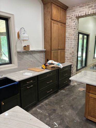 Modern kitchen interior with dark and wood cabinets.