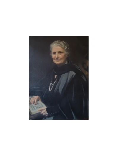 Portrait of an elegant elderly woman holding a book, dressed in dark attire with pearls.
