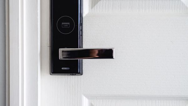 Close-up of a modern electronic door lock with a card access system.