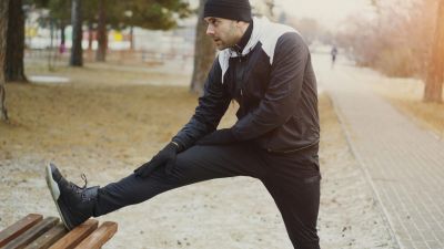 Man stretching in park