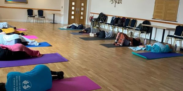 Group yoga meditation session at the Con Club in Seaford