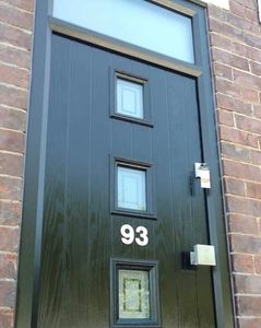 Black Brown composite front door with matching grey frame, square handle and a top light.