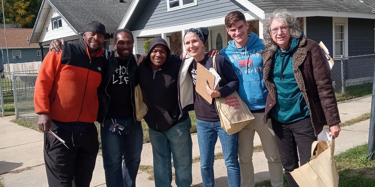 group of Voices for Life volunteers pictured with prolife residents while canvassing.