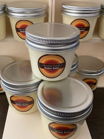 Small jars of Almond Toast Butter Balm with retro-style labels.