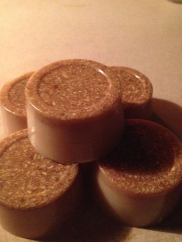 Stacked cork-topped containers on a surface.