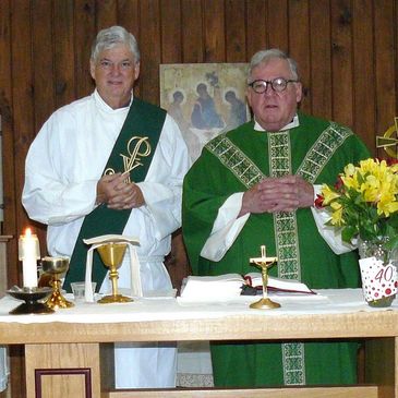 Monsignor Stephen Bosso celebrates Mass at an AIM retreat with Deacon John assisting him.