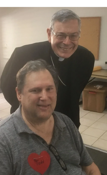 Bishop Gerald Barbarito greets a retreatant at AIM's 40th Anniversary weekend retreat.