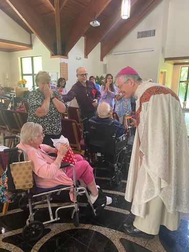 Bishop Barbarito greets AIM co-founder Harriet Molinski.