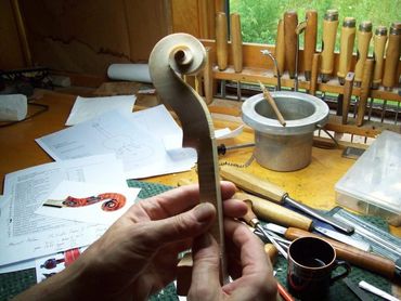 Partially built guitar body clamped for woodwork shaping
