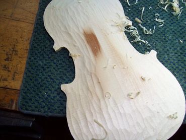 Guitar body construction with clamping jig in workshop