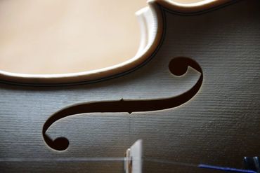 Custom guitar body held in jig for contour carving