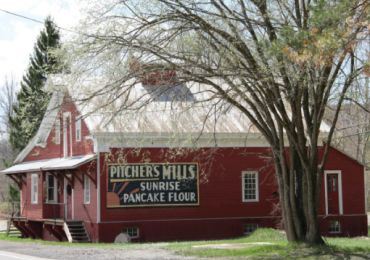 Red building with a sign advertising Sunrise Pancake Flour.