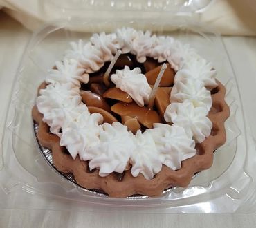 Small tart with whipped cream and caramel topping.