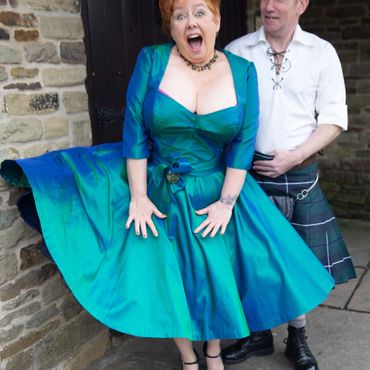 Jen on her wedding day in a 50s style thai shot silk dress .