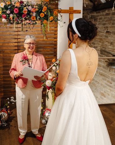 Jen dressed in cream tapered trousers and a peachy linen jacket to match the wedding theme