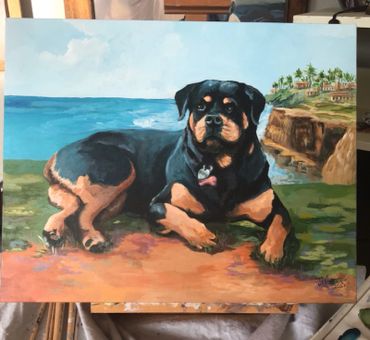 Painting of black rottweiler with background of LaJOLLA, CA ocean and cliffs. sand and green