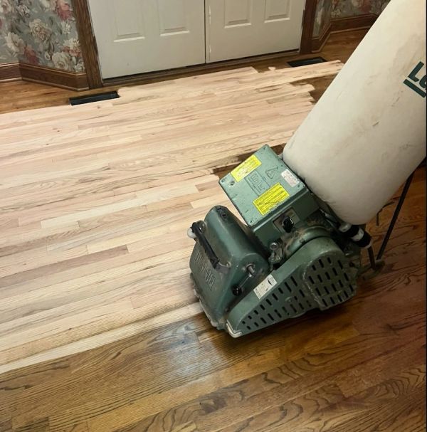 Sanding down to bare wood in a Rocky River, Ohio, living room.