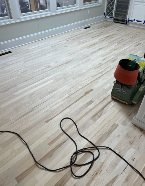 Hardwood floor sanding during a refinishing project in Solon