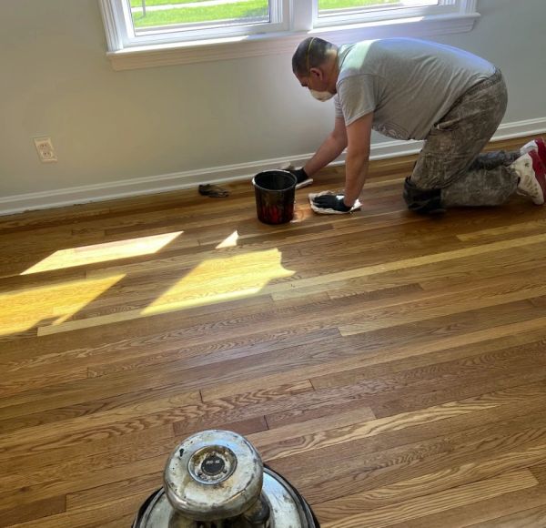 Hardwood floor stain is being applied in a Brecksville, Ohio home.