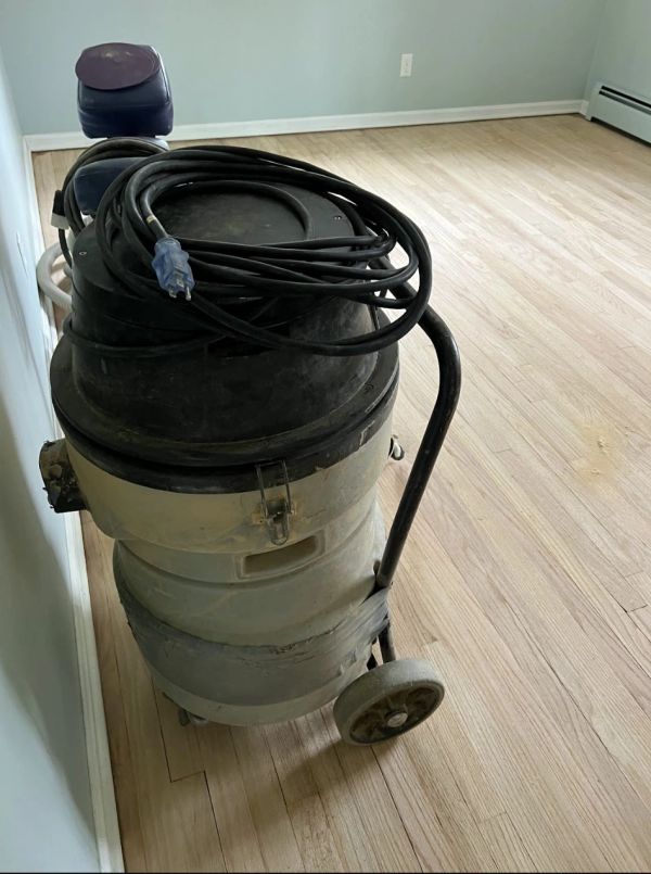 Dust-controlled hardwood floor sanding HEPA filtered equipment in use