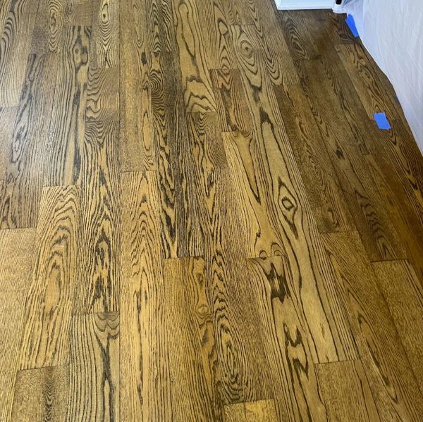Restaining hardwood floors in North Ridgeville, Ohio. Rich dark walnut stain applied to oak floors.