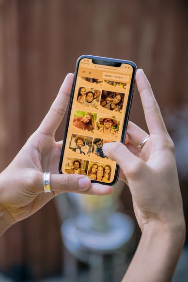 person watching photo on phone -  St. Louis