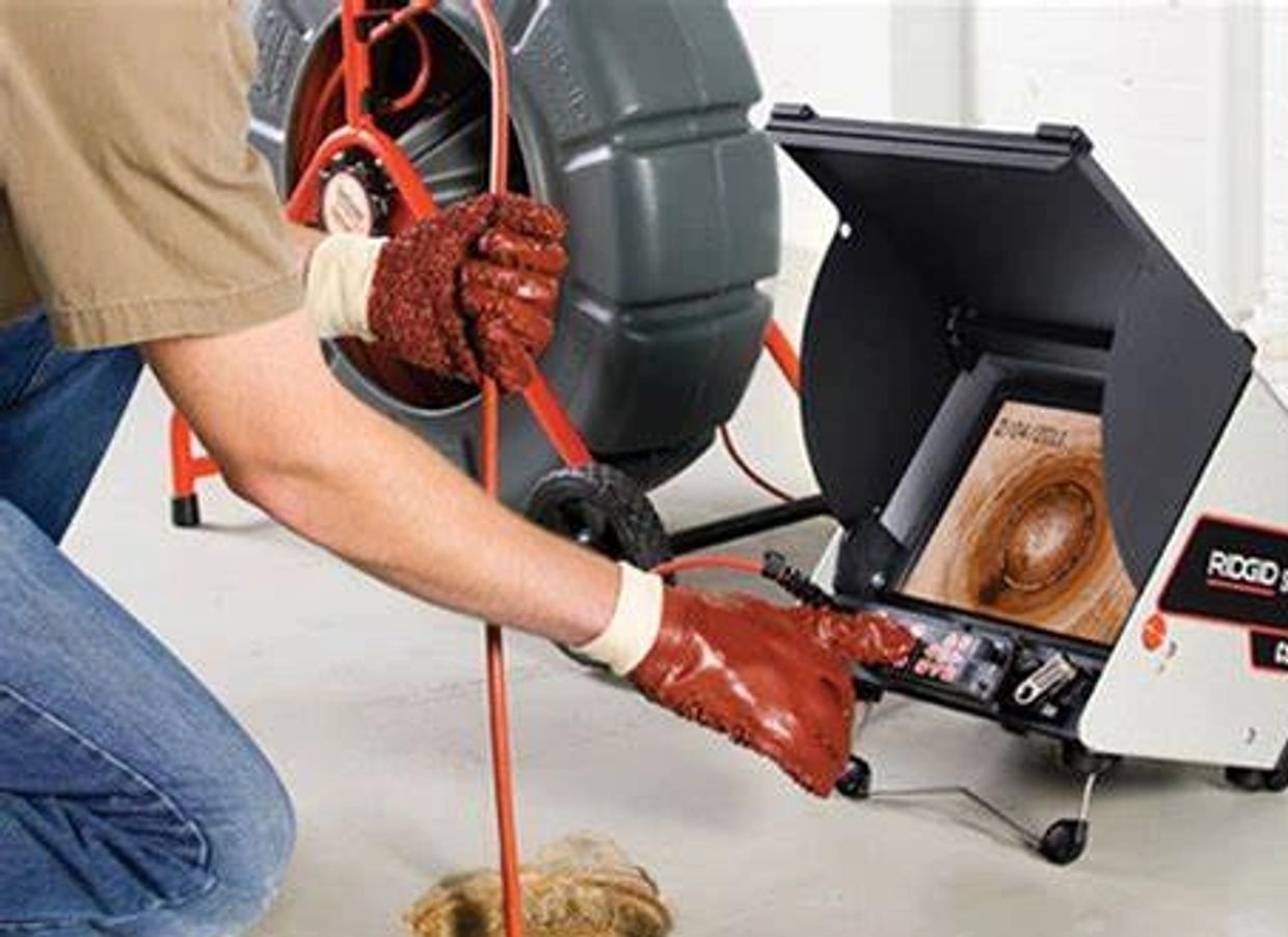 Person using a drain inspection camera to check a pipe.