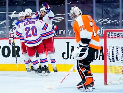 Philadelphia Flyers goaltender Carter Hart watches the New York Rangers celebrate again.