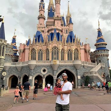 Moe at Disney World holding daughter